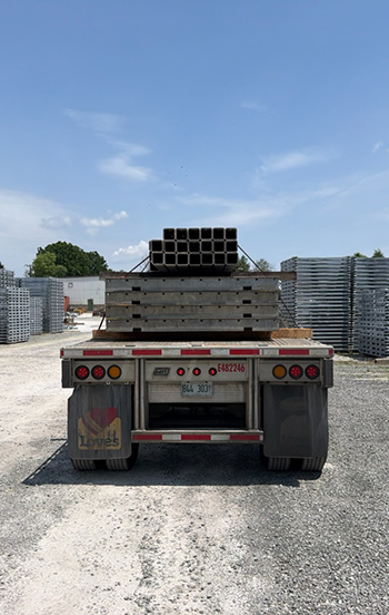 Structural steel beams loaded on a Buchanan Hauling flatbed trailer for commercial freight transportation.