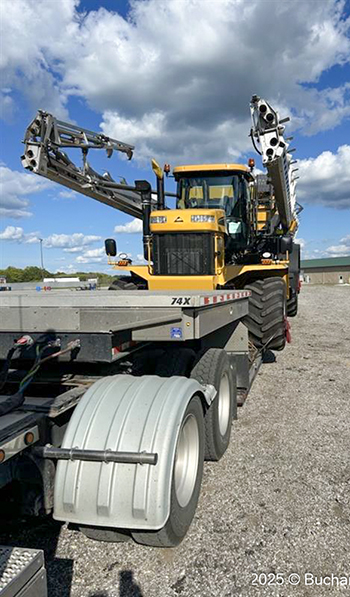 Heavy equipment positioned on a lowboy trailer for transportation by Buchanan Hauling and Rigging.