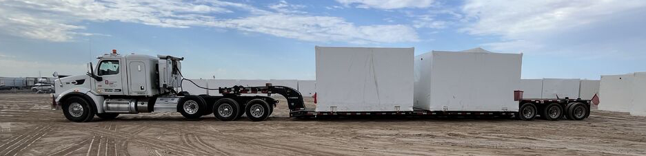 Removable gooseneck trailer configured for loading heavy machinery for specialized transportation.