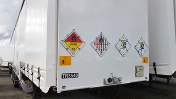Industrial chemical freight prepared for transportation with Buchanan Hauling specialized trucking equipment.