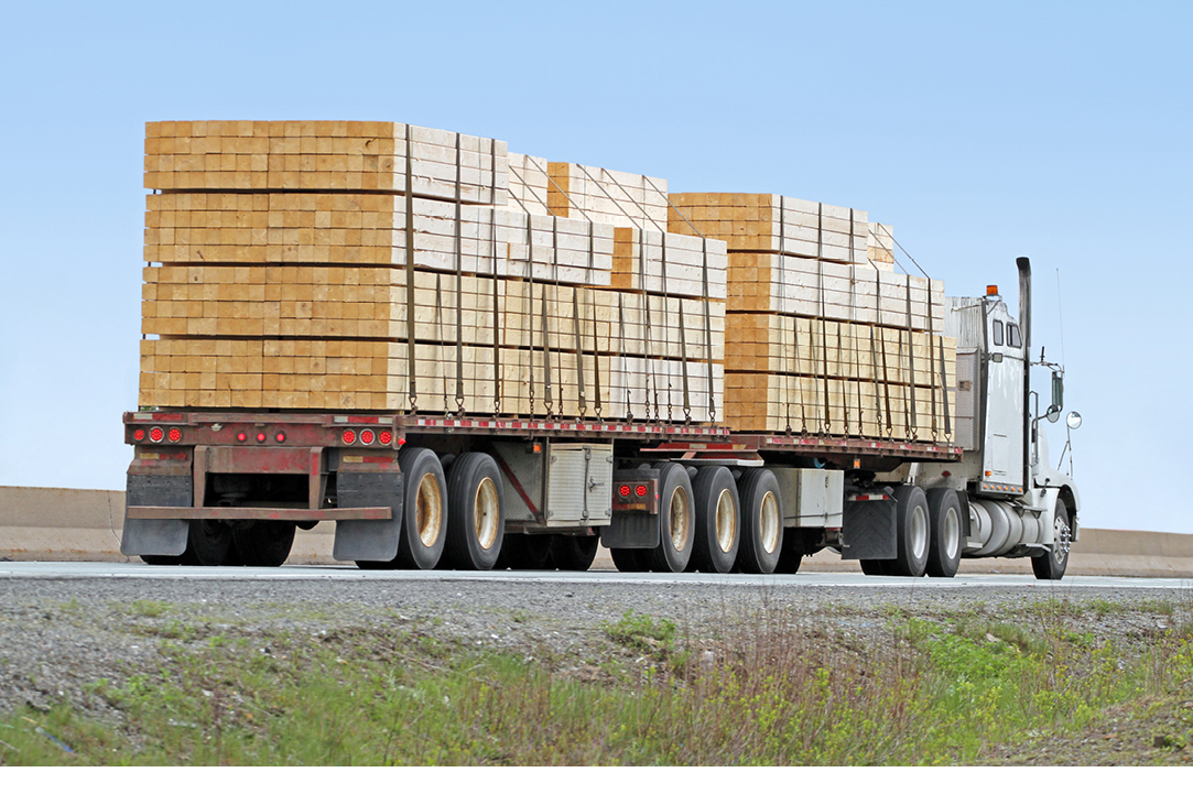 Semi flatbed truck carrying wood