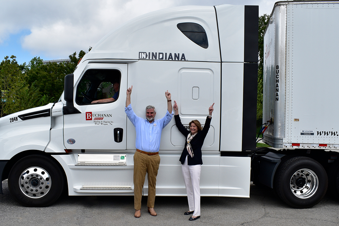 Governor Eric Holcomb pointing to the Buchanan Truck with the words IN Indiana