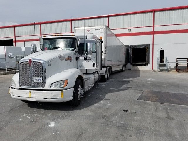 A Buchanan Hauling dry van truck parked at a terminal for delivery of freight.