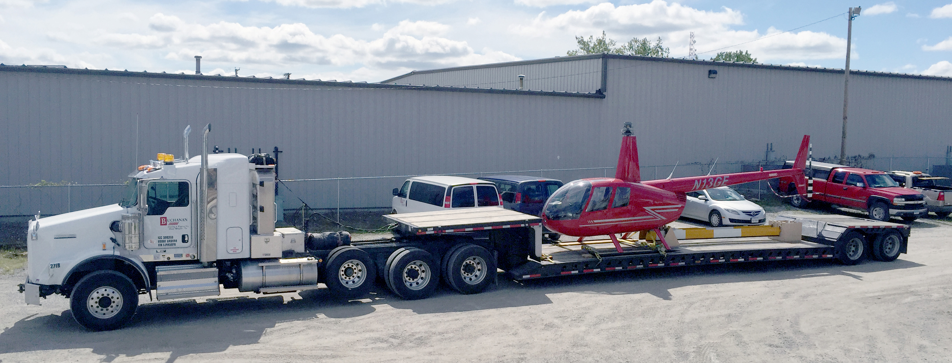 Buchanan transporting a helicopter with one of their step deck trailers for a specialized transport.