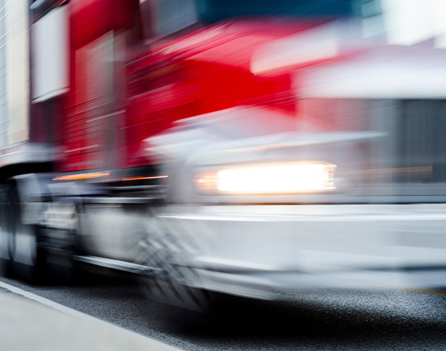 Expedited freight truck transporting urgent cargo across interstate highway.