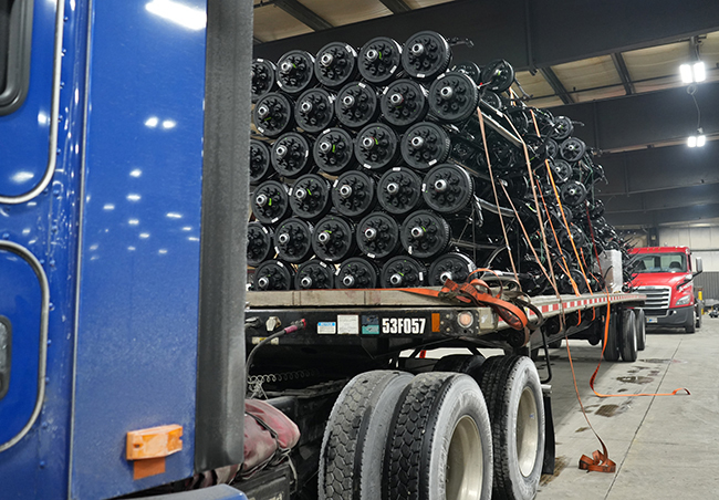 Urgent industrial parts shipment loaded onto commercial freight truck.
