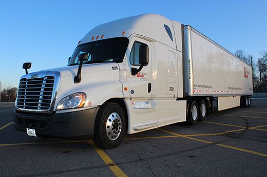 Commercial truck transporting time critical freight shipment across interstate.