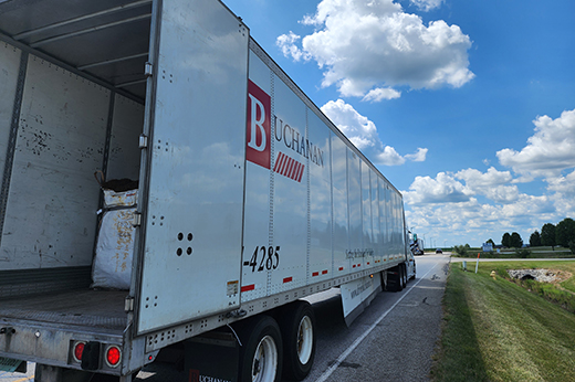 Asset based trucking company fleet transporting freight across highway.