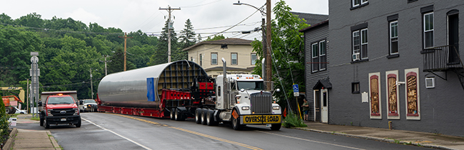 Heavy haul trailer carrying a large cylindrical tank during industrial transport Heavy haul trailer carrying a large cylindrical tank during industrial transport