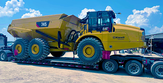 Oversized freight transport truck hauling heavy construction equipment