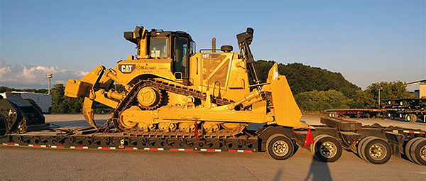 versized freight shipping heavy construction equipment on highway
