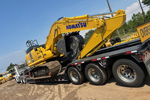 Heavy haul trucking transporting large construction machinery across interstate