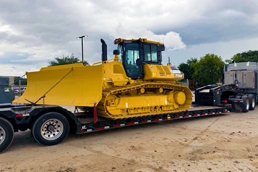 Bulldozer loaded on lowboy trailer for heavy equipment hauling