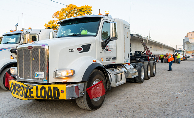 Oversized freight transporting bridge components for infrastructure project
