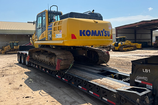 Heavy haul trailer transporting construction equipment to infrastructure job site