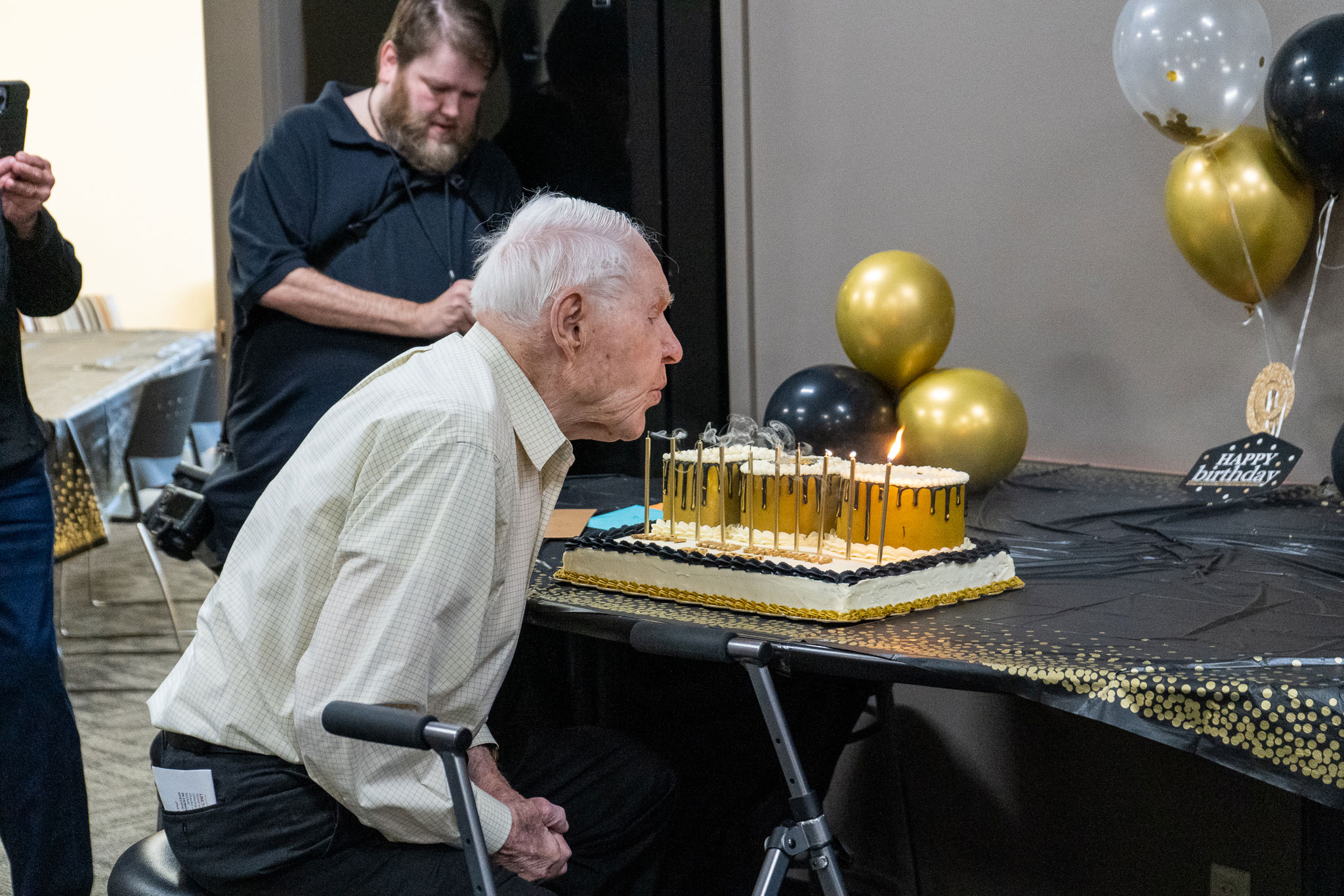 Bob Jesse blowing out his candles for his 100th birthday celebration
