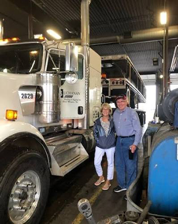 Geary and Becky Buchanan beside one of their trucks Geary and Becky Buchanan beside one of their trucks