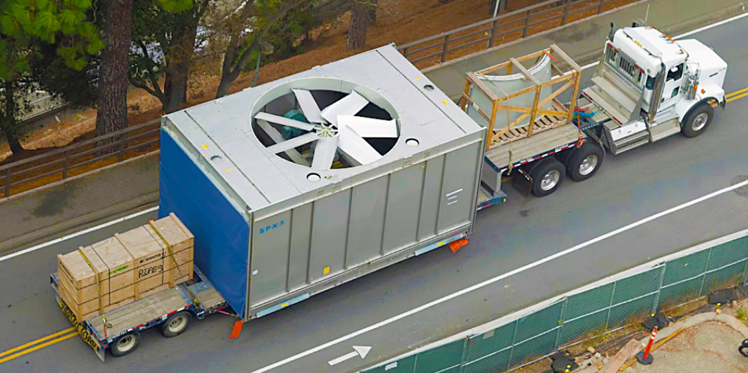 Massive HVAC unit in transit to a commercial site.