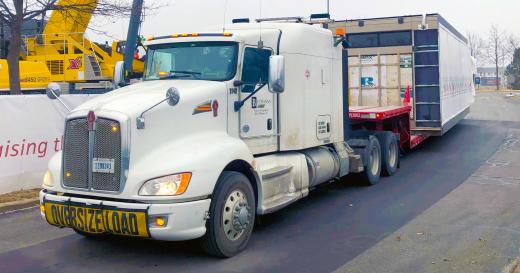 Buchanan Hauling and Rigging transports an HVAC unit on one of their stepdeck trailers to a hospital construction crew jobsite. Buchanan Hauling and Rigging transports an HVAC unit on one of their stepdeck trailers to a hospital construction crew jobsite.