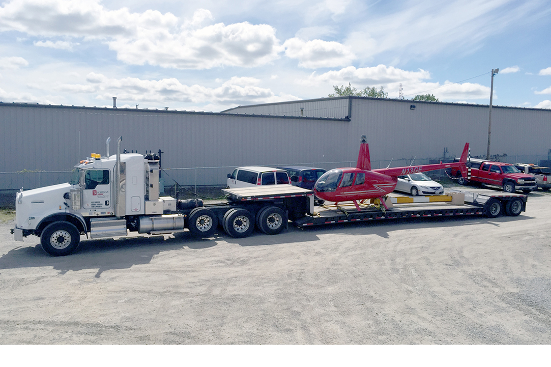 Buchanan Hauling and Rigging transporting a customer's helicopter with one of our RGN trailers.