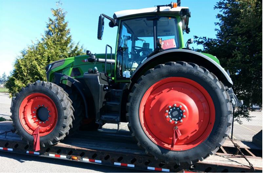 Buchanan Hauling & Rigging delivering a farm tractor to its destination.