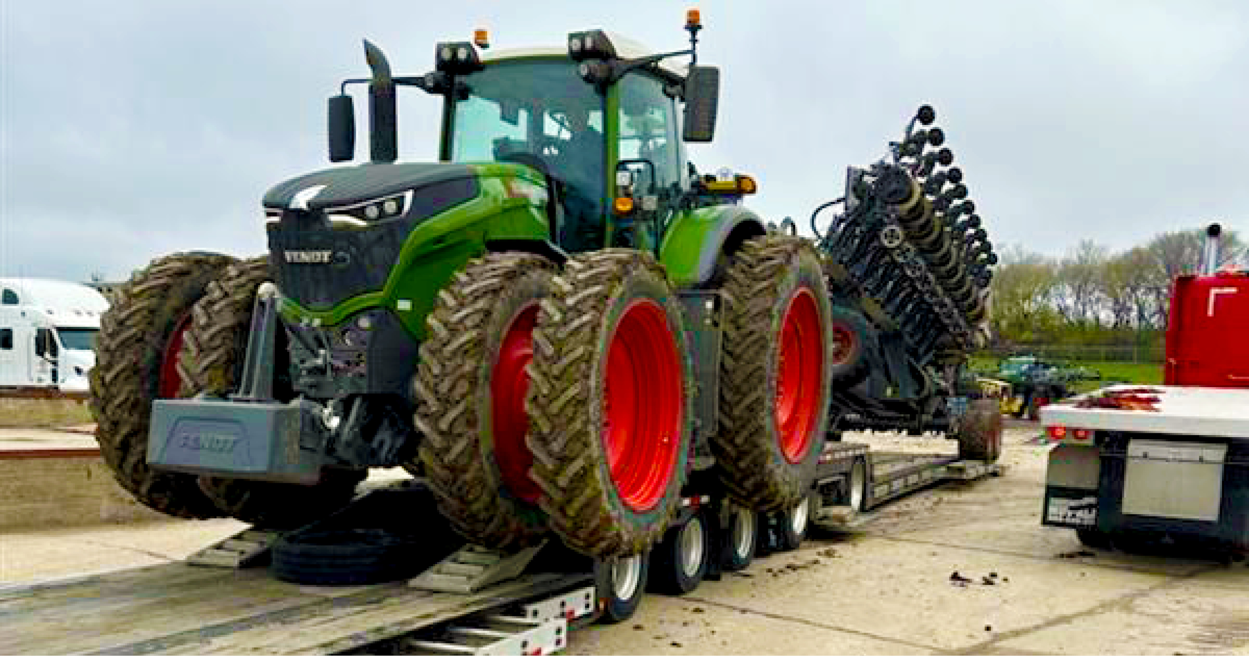 Buchanan Hauling using one of our RGN trailers to move a farm tractor.