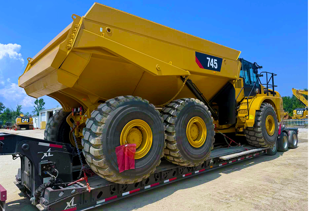 Buchanan Hauling and Rigging Heavy Haul Division transporting a dump truck to a jobsite to be used for construction.
