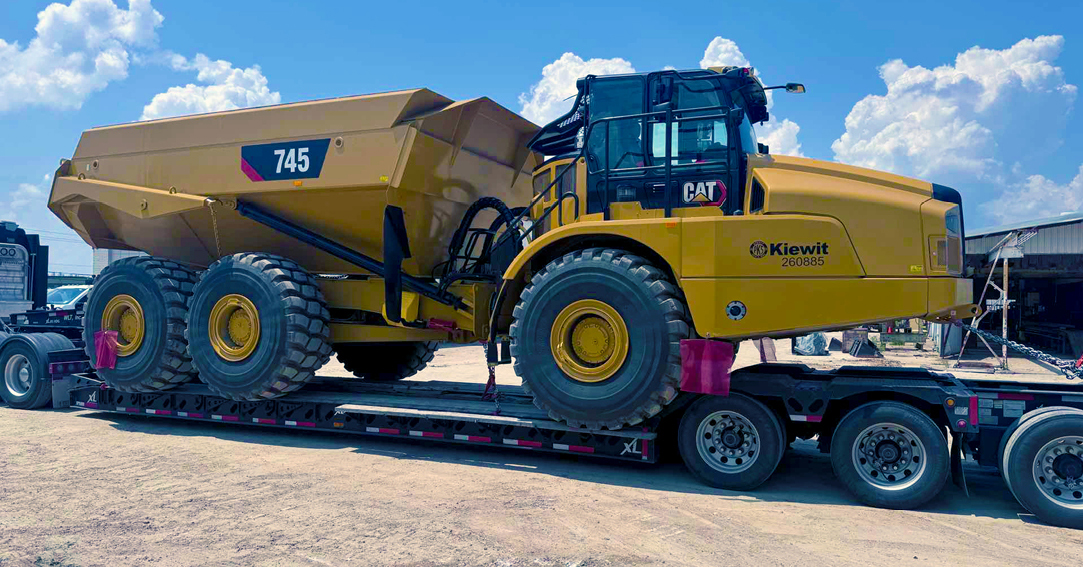 Buchanan Hauling and Rigging Heavy Haul Division transporting a piece of construction equipment machinery to a jobsite to be used for construction.