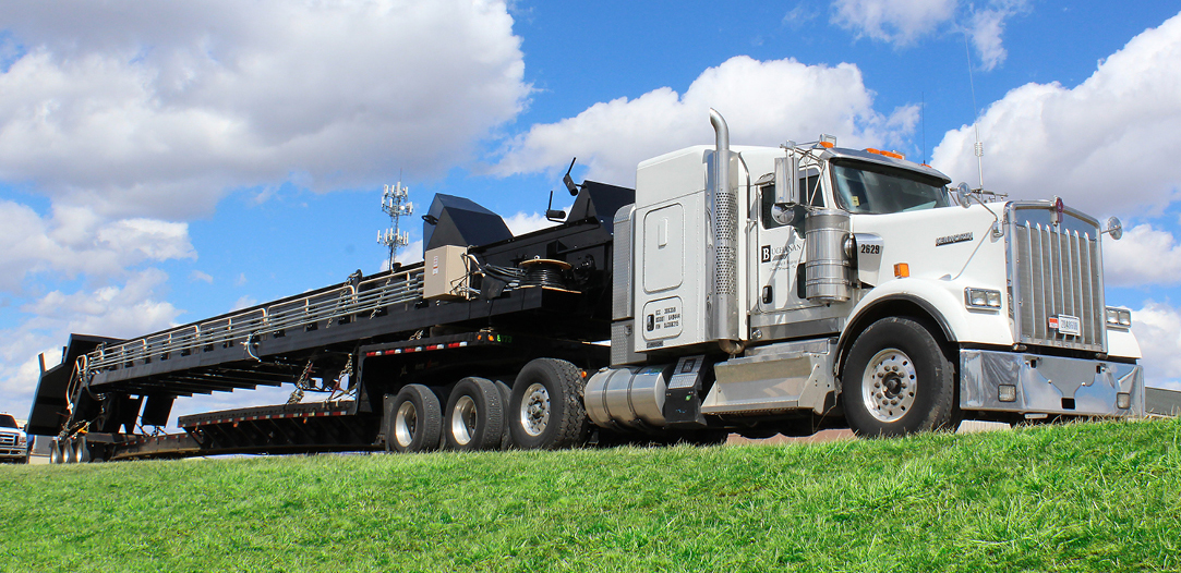 Buchanan Hauling and Rigging transports a conveyor system using their stepdeck trailer.