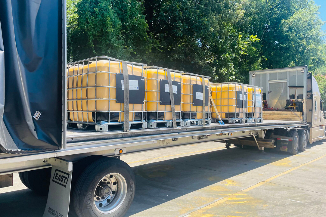 Buchanan Hauling and Rigging Conestoga flatbed truck hauling freight for a customer.