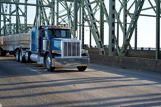 Commercial truck crossing a bridge with legal weight calculations