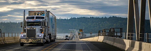 Professional truck driver and Buchanan equipment representing family values, accountability, and safe transportation services.