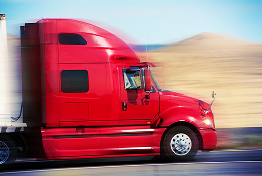 Commercial tractor trailer operating safely on the highway representing the SAFE Act and responsible freight transportation.