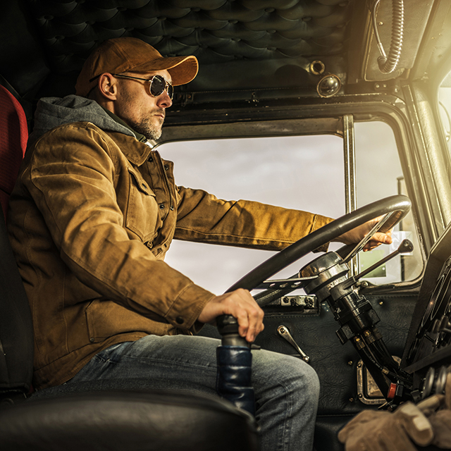 Truck driver rolls out after using the clean roadside inspection checklist to clear his semi for travel.