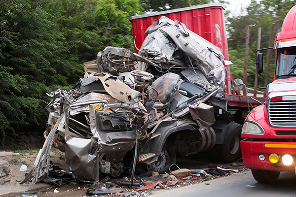 Mangled cab of a semi truck that took damage