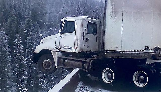 A driver almost had an even more bad day after this bad accident on icy roads took him to the edge.