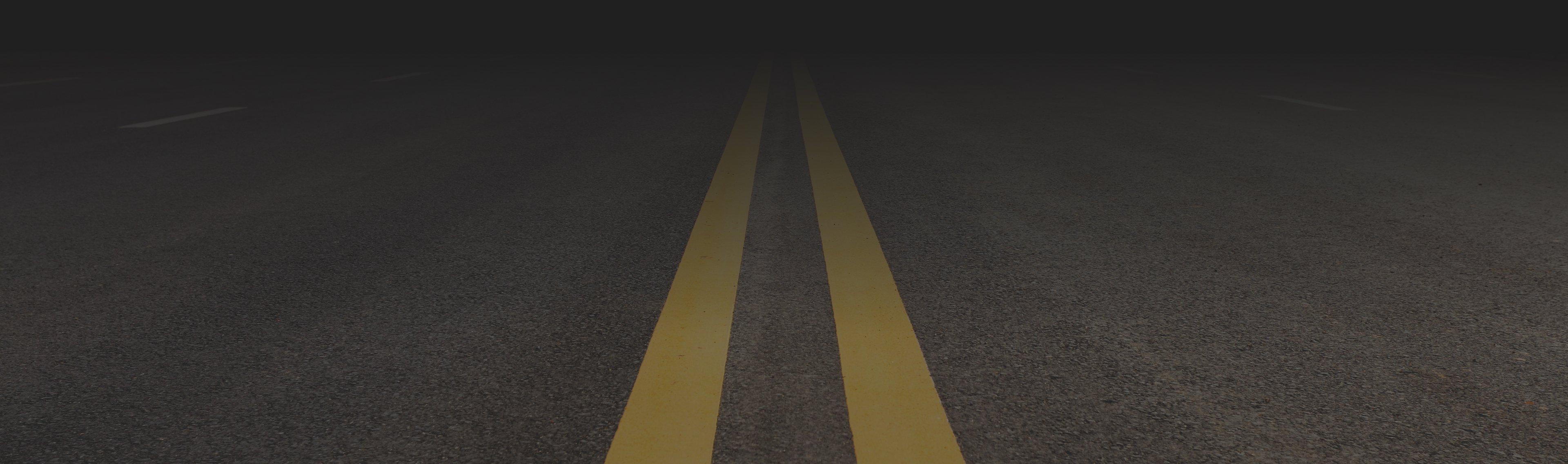 Road with center line up-close leading into distant vanishing point